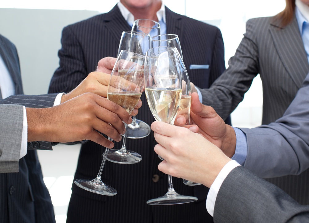 Close-up of business team toasting with Champagne in the office